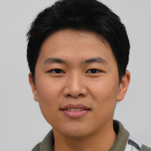 Joyful asian young-adult male with short  black hair and brown eyes