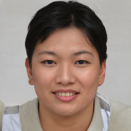 Joyful asian young-adult female with short  brown hair and brown eyes