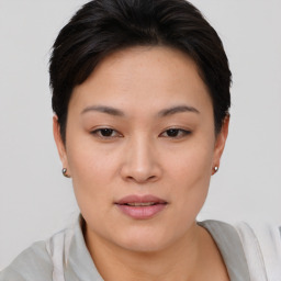 Joyful asian young-adult female with short  brown hair and brown eyes