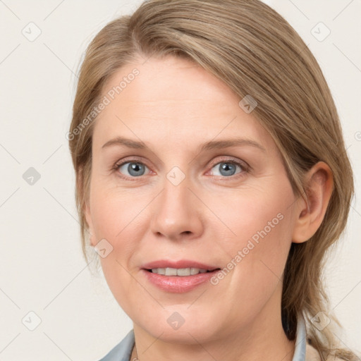 Joyful white adult female with medium  brown hair and blue eyes