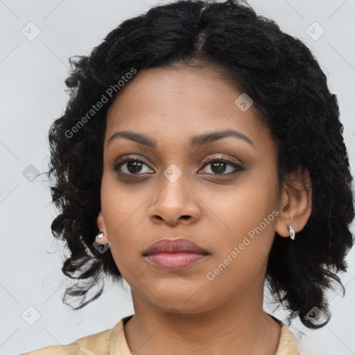 Joyful black young-adult female with long  black hair and brown eyes