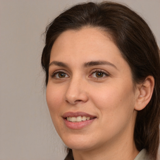 Joyful white young-adult female with medium  brown hair and brown eyes