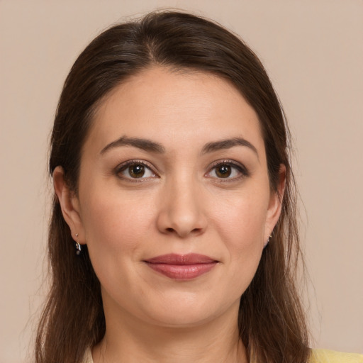 Joyful white young-adult female with long  brown hair and brown eyes