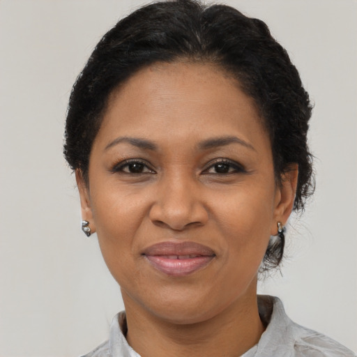 Joyful black adult female with short  brown hair and brown eyes