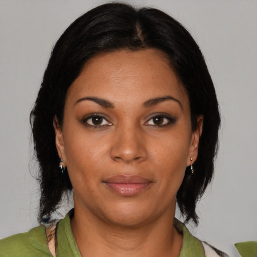 Joyful black young-adult female with medium  brown hair and brown eyes