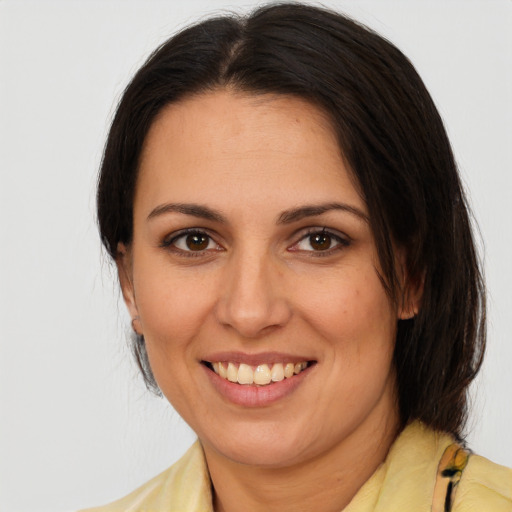 Joyful white adult female with medium  brown hair and brown eyes