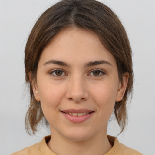 Joyful white young-adult female with medium  brown hair and brown eyes