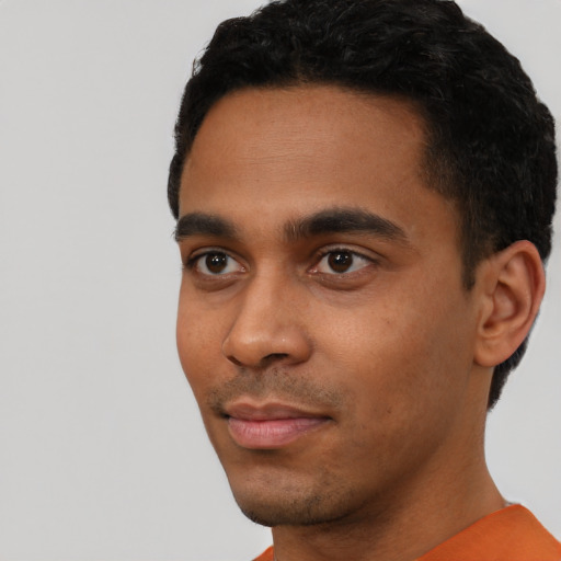 Neutral black young-adult male with short  black hair and brown eyes