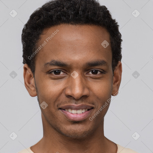 Joyful black young-adult male with short  black hair and brown eyes