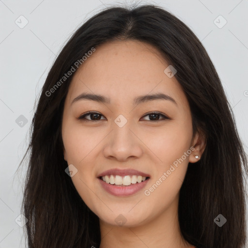 Joyful asian young-adult female with long  brown hair and brown eyes