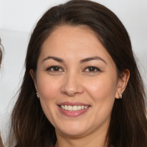 Joyful white adult female with long  brown hair and brown eyes
