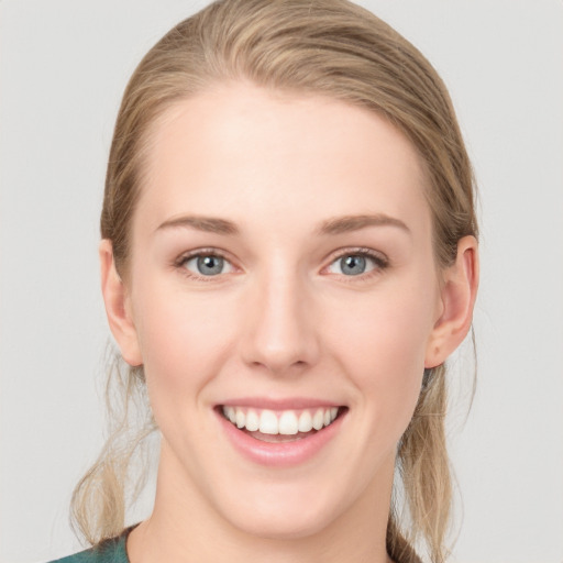 Joyful white young-adult female with long  brown hair and blue eyes