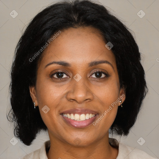 Joyful black adult female with medium  brown hair and brown eyes