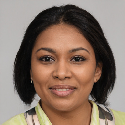 Joyful latino young-adult female with medium  black hair and brown eyes