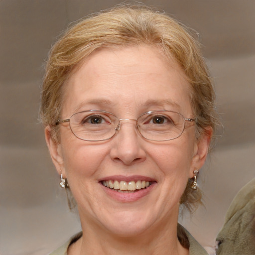 Joyful white middle-aged female with medium  brown hair and blue eyes