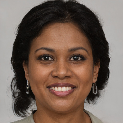Joyful black young-adult female with medium  brown hair and brown eyes
