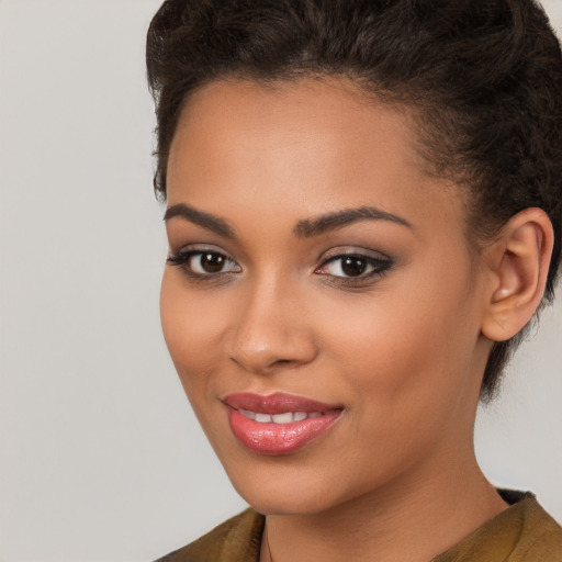 Joyful latino young-adult female with short  brown hair and brown eyes