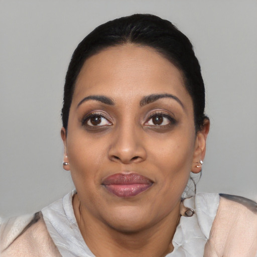 Joyful latino young-adult female with short  black hair and brown eyes