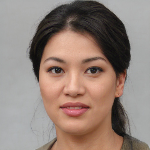 Joyful asian young-adult female with medium  brown hair and brown eyes