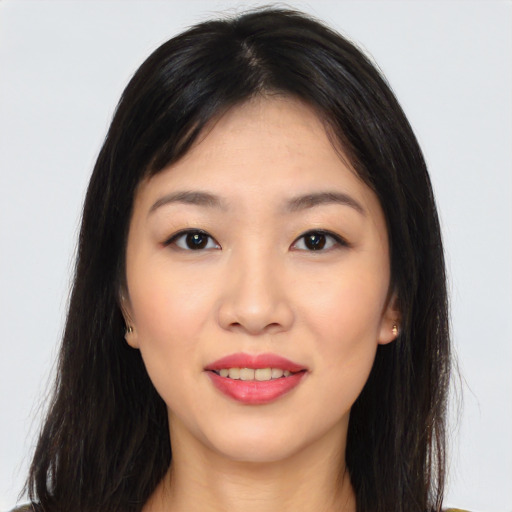Joyful asian young-adult female with long  brown hair and brown eyes