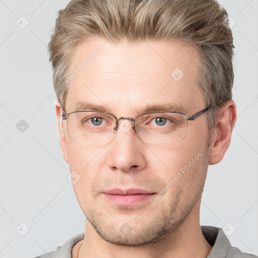 Joyful white adult male with short  brown hair and grey eyes