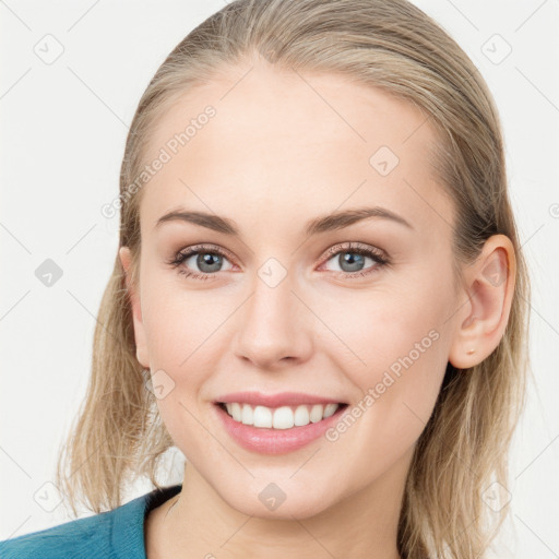 Joyful white young-adult female with medium  brown hair and blue eyes