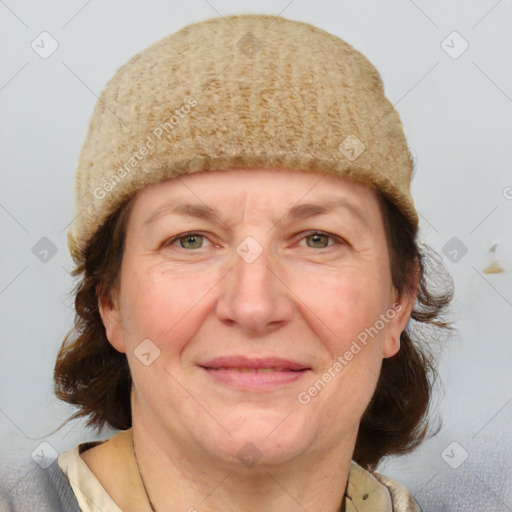 Joyful white adult female with medium  brown hair and blue eyes