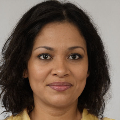 Joyful black adult female with medium  brown hair and brown eyes