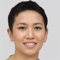 Joyful asian young-adult female with short  brown hair and brown eyes