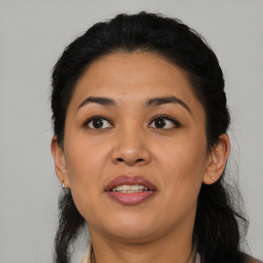 Joyful latino young-adult female with medium  black hair and brown eyes