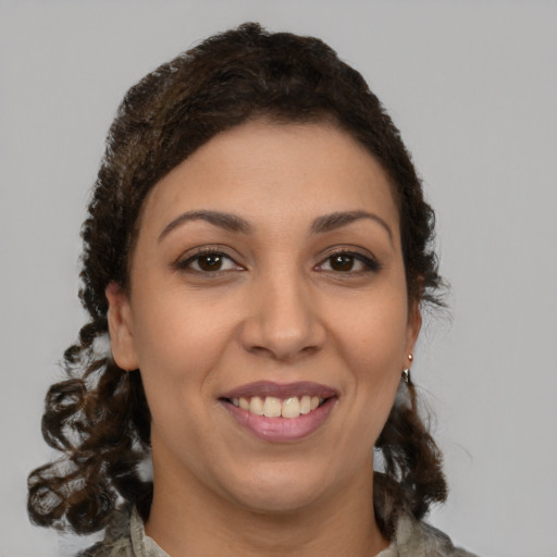 Joyful latino young-adult female with medium  brown hair and brown eyes