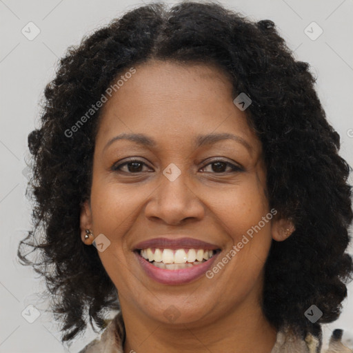 Joyful black adult female with medium  brown hair and brown eyes