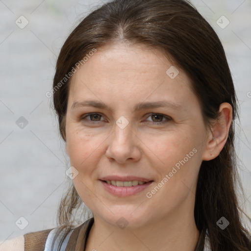 Joyful white adult female with long  brown hair and brown eyes