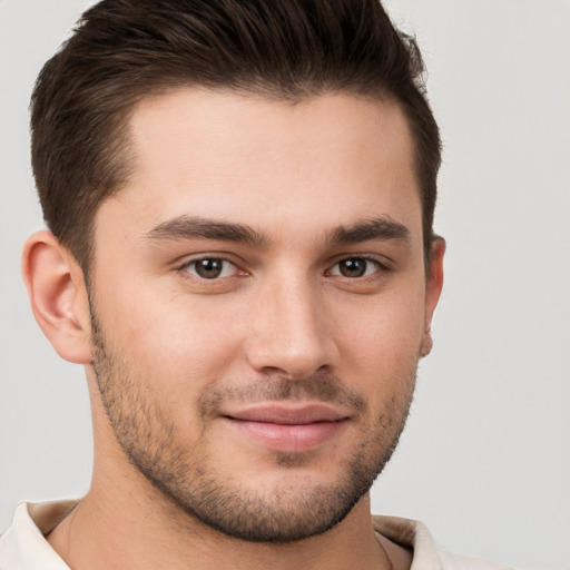 Joyful white young-adult male with short  brown hair and brown eyes