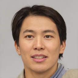 Joyful asian young-adult male with short  brown hair and brown eyes