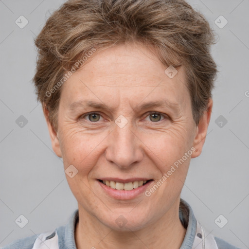 Joyful white adult female with short  brown hair and grey eyes