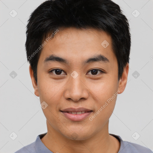 Joyful asian young-adult male with short  black hair and brown eyes