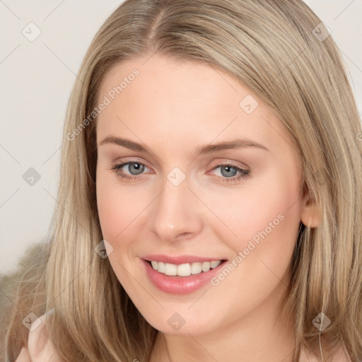 Joyful white young-adult female with long  brown hair and grey eyes