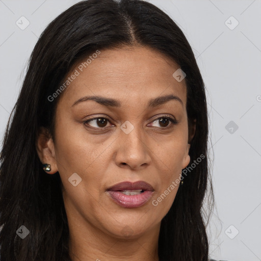 Joyful black adult female with long  brown hair and brown eyes