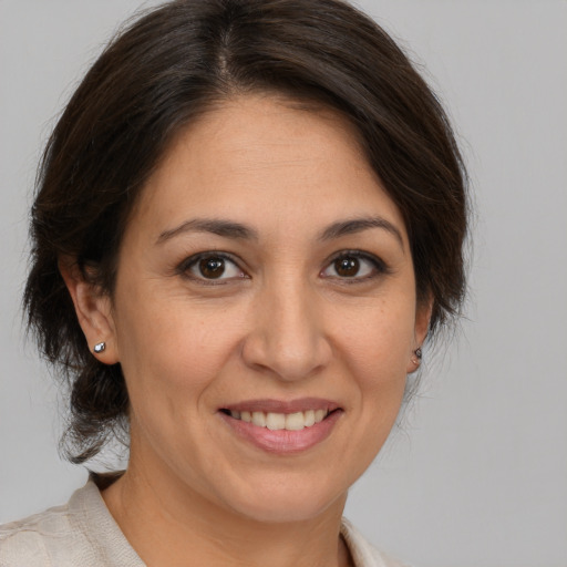 Joyful white adult female with medium  brown hair and brown eyes