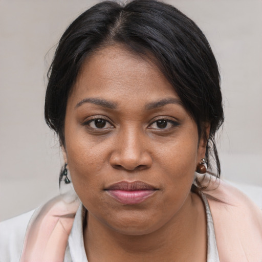 Joyful black young-adult female with medium  brown hair and brown eyes