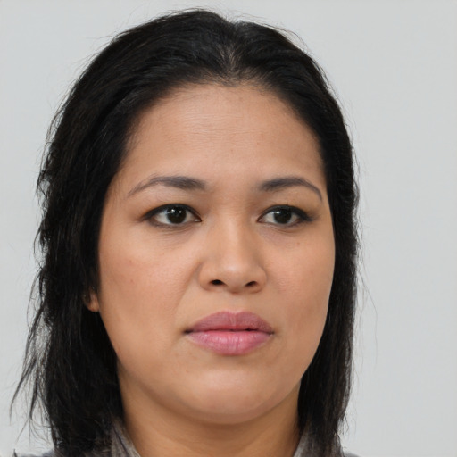 Joyful asian young-adult female with long  brown hair and brown eyes