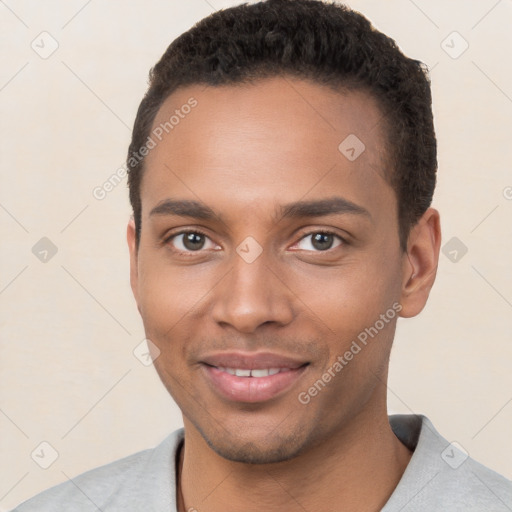 Joyful black young-adult male with short  brown hair and brown eyes