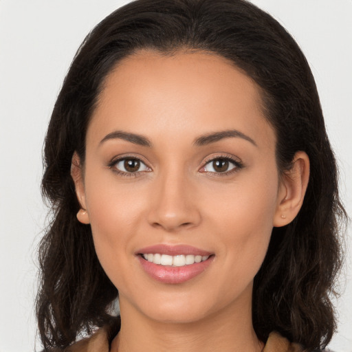 Joyful white young-adult female with long  brown hair and brown eyes