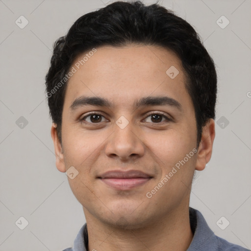 Joyful latino young-adult male with short  black hair and brown eyes