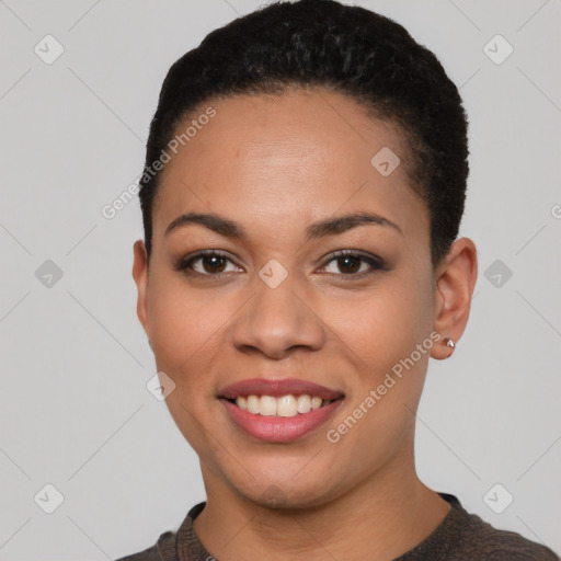 Joyful black young-adult female with short  black hair and brown eyes