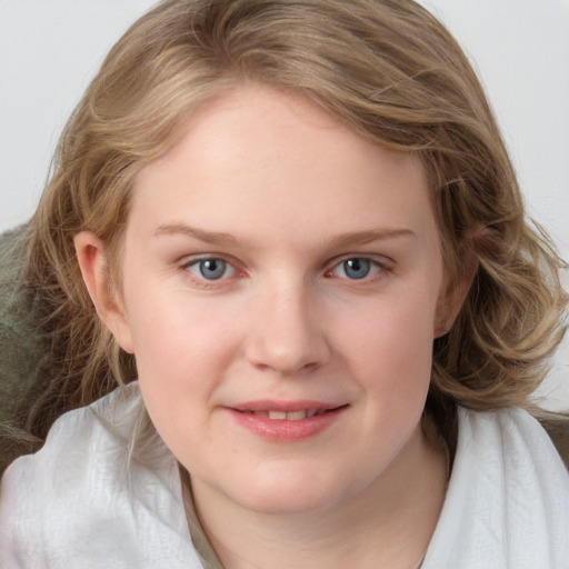 Joyful white young-adult female with medium  brown hair and blue eyes