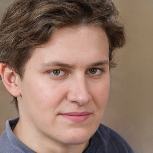 Joyful white young-adult male with medium  brown hair and grey eyes