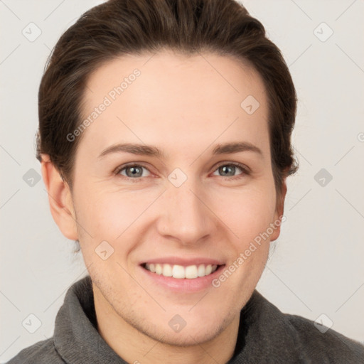 Joyful white young-adult female with short  brown hair and grey eyes