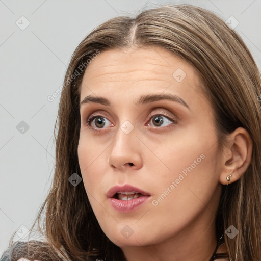 Neutral white young-adult female with long  brown hair and brown eyes